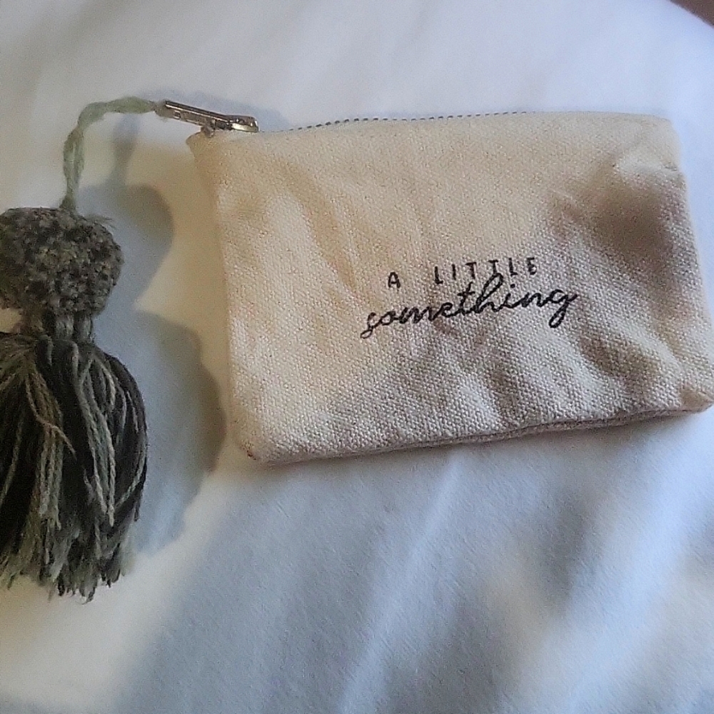 little change purse made of hemp 1 side it says a little something other karma
